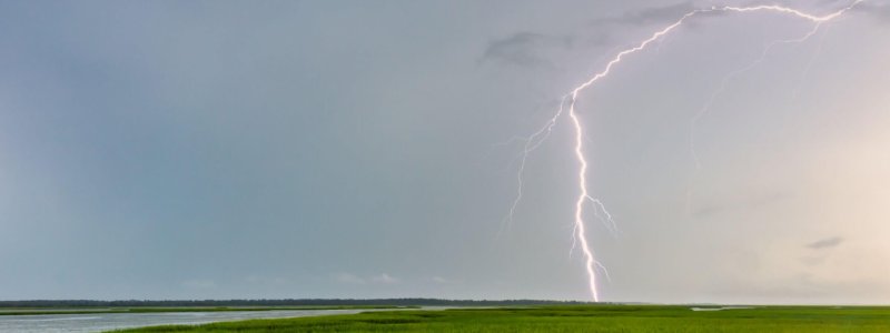 Beautiful shot of a lightning strike in the daytime A beautiful shot of a lightning strike in the daytime